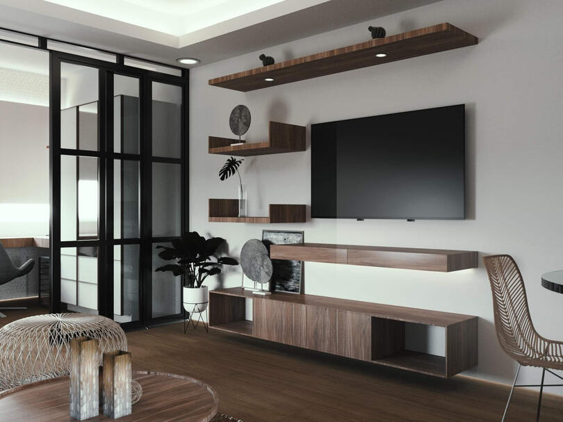 The glass partitions separate the bed from the rest of the studio.